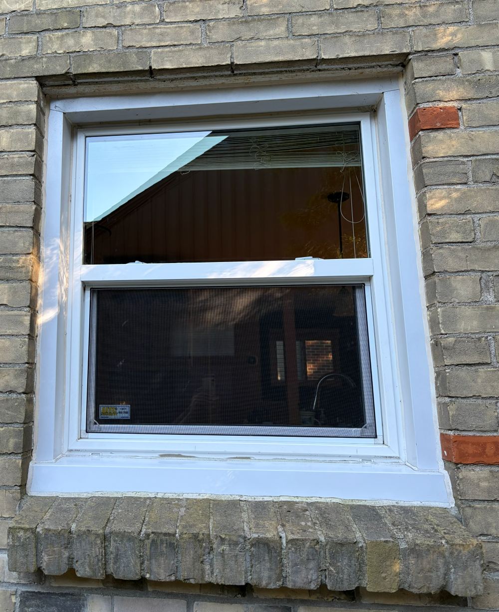 The same kitchen window after cleaning, with the screen washed and re-fitted