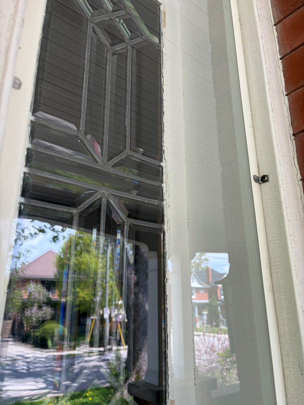 The same leaded-glass window after cleaning, with clear glass and crisp reflections