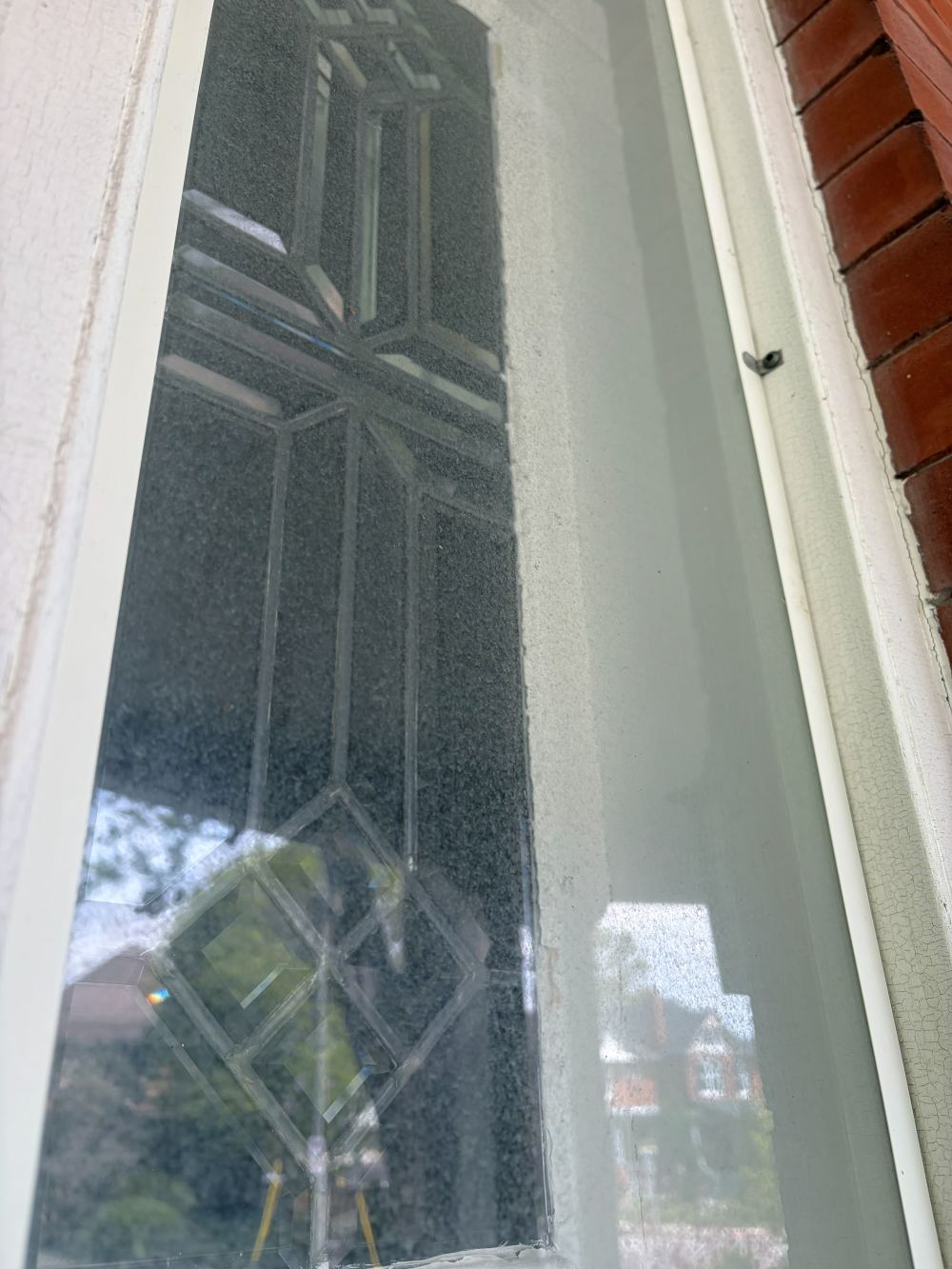 Leaded-glass window before cleaning, covered in a dusty film
