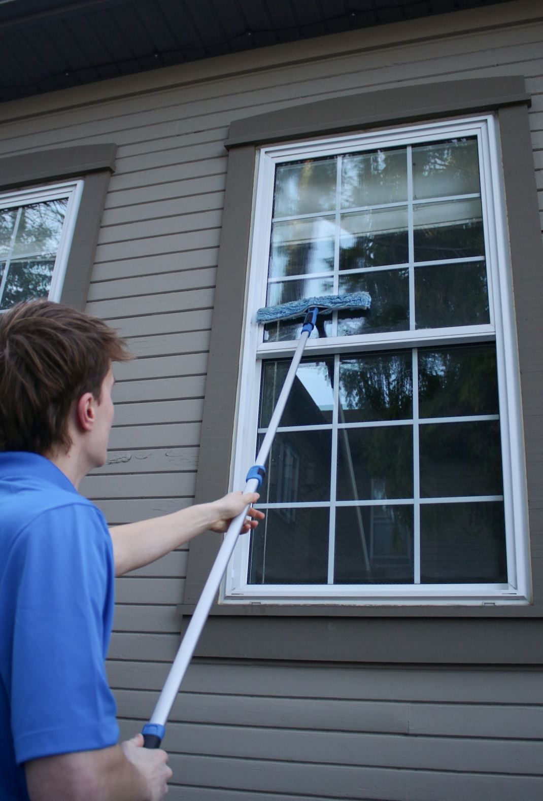 Washing an exterior window with a pole-mounted scrubber
